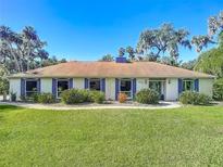 Charming ranch home with a manicured lawn and walkway at 544 Stone Island Rd, Enterprise, FL 32725