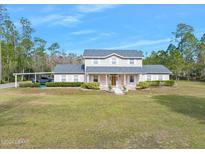 Two-story house with covered porch and large yard at 3782 Pine Cone Ln, Ormond Beach, FL 32174