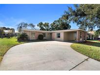 Ranch-style home with a carport and well-manicured lawn at 454 Ellsworth St, Altamonte Springs, FL 32701