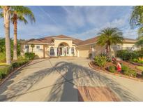 Beautiful one-story home with a large driveway and lush landscaping at 614 Mura Ct, New Smyrna Beach, FL 32168