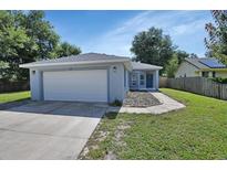 Newly built home with a two-car garage and landscaped yard at 347 Redwood Ave, Orange City, FL 32763