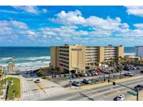 Oceanfront building, parking lot, and surrounding streets are shown in this aerial view at 3501 S Atlantic Ave # 2030, Daytona Beach, FL 32118