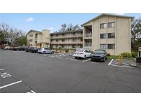 Two-story condo building with ample parking and landscaping at 633 S Palmetto Ave # 1010, Daytona Beach, FL 32114