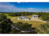 Aerial view of a house, barn, and expansive land at 575 Alderman Rd, Lakeland, FL 33810