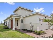 Modern villa with orange door and attached garage at 2541 Yellow Brick Rd, Saint Cloud, FL 34772