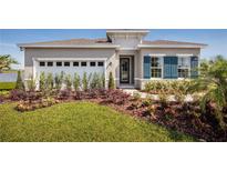 Single-story home with two-car garage and landscaped yard at 5769 Anders Way, St Cloud, FL 34771