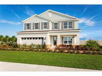 Two-story house with gray siding, shutters, and landscaping at 290 Prickly Pear Ct, Lady Lake, FL 32159