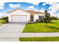 Modern home with a two-car garage and attractive landscaping at 1649 Laia Rd, Haines City, FL 33844