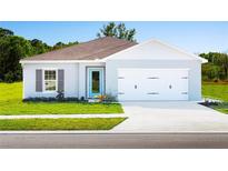 Single-story home with two-car garage and attractive landscaping at 1602 Minnesota Rd, Sumterville, FL 33585