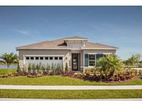 Single-story home with a two-car garage and landscaped yard at 2613 Chestnut Valley Way, New Smyrna Beach, FL 32168