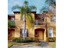 Two-story townhome with attractive exterior and landscaping at 216 Calabria Ave, Davenport, FL 33897