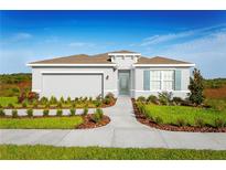 One-story home with gray siding, brown roof, and landscaped yard at 353 Crestwind Dr, Daytona Beach, FL 32124