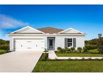 One-story home with attached garage, landscaping, and walkway at 1661 Laia Rd, Haines City, FL 33844