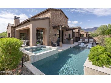 Luxury home with a spacious pool, spa, and covered patio area at 3119 S Prospector Cir, Gold Canyon, AZ 85118