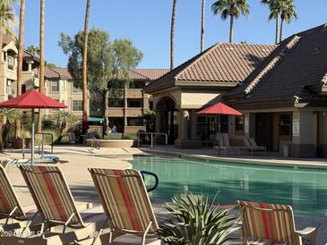 Inviting pool area with lounge chairs and umbrellas at 14950 W Mountain View Blvd # 7105, Surprise, AZ 85374