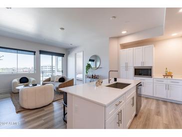 Modern kitchen with white cabinets, stainless steel appliances, and a large island at 3131 N Central Ave # 3011, Phoenix, AZ 85012