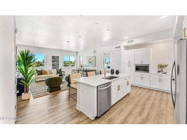 Modern kitchen with white shaker cabinets, stainless steel appliances, and an island at 3131 N Central Ave # 4012, Phoenix, AZ 85012