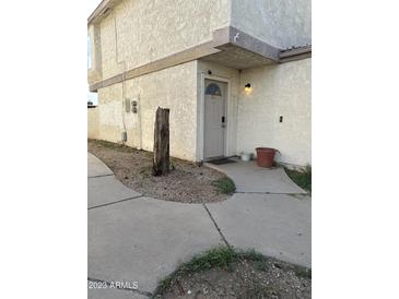 Exterior view of building with walkway and landscaping at 3840 N 43 Ave # 50, Phoenix, AZ 85031