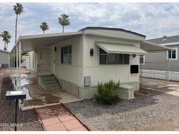 Mobile home with carport and brick walkway at 7300 N 51St Ave # 208, Glendale, AZ 85301