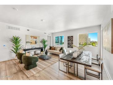 Open living area with hardwood floors, modern furniture, and city views at 3131 N Central Ave # 3018, Phoenix, AZ 85012