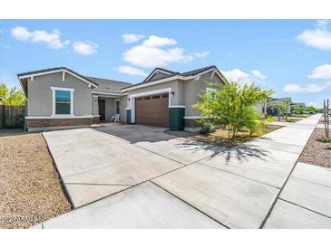 Single-story home with a two-car garage and well-manicured landscaping at 21088 E Arroyo Verde Dr, Queen Creek, AZ 85142