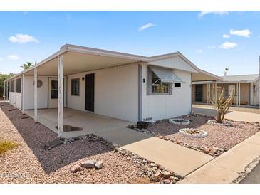 Mobile home with carport and desert landscaping at 3330 E Main St # 9, Mesa, AZ 85213