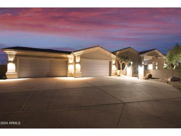 Elegant home exterior with a two-car garage at dusk at 6990 E Buckhorn Trl, Scottsdale, AZ 85266
