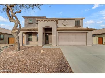 Two-story house with neutral exterior, attached garage, and landscaping at 22348 N Braden Rd, Maricopa, AZ 85138