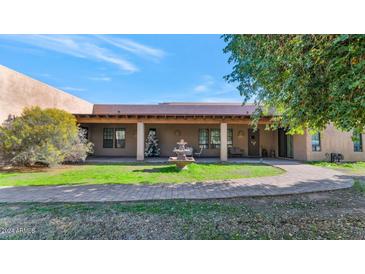 Charming home exterior with a covered patio and fountain at 9703 N 175Th Ave, Waddell, AZ 85355