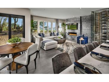 Spacious great room with fireplace, wine cellar, and golf course views at 37200 N Cave Creek Road Rd # 1125, Scottsdale, AZ 85262