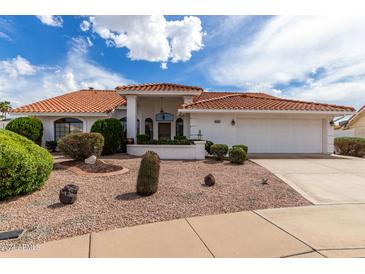 Single-story house with a two-car garage and desert landscaping at 8351 E Monte Ave, Mesa, AZ 85209
