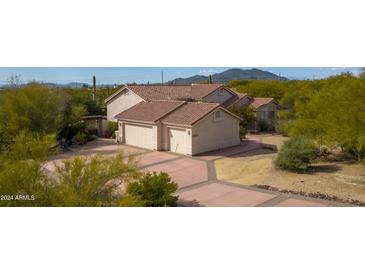 Two-car garage and a large driveway with desert landscaping at 39012 N 8Th St, Phoenix, AZ 85086