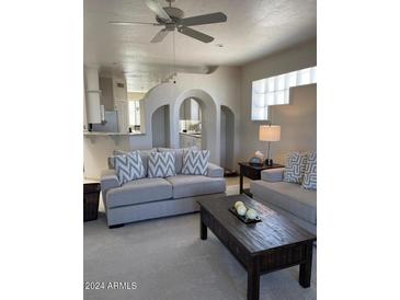 Spacious living room with comfortable seating and a view of the kitchen at 11011 N Zephyr Dr # 210, Fountain Hills, AZ 85268