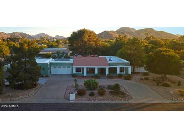 Stunning aerial view of a home nestled in a scenic mountain setting at 4601 E Desert Cove Ave, Phoenix, AZ 85028