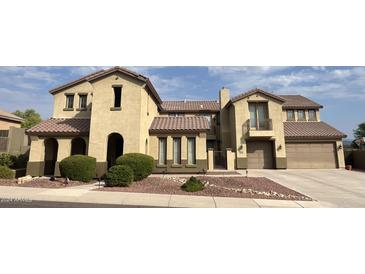 Two-story house with tan exterior and landscaping at 38730 N Donovan Ln, Phoenix, AZ 85086