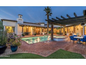Luxury backyard oasis with a sparkling pool, spa, and covered patio at 5842 E Redwing Rd, Paradise Valley, AZ 85253