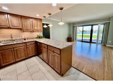 Modern kitchen with granite countertops and stainless steel appliances at 10330 W Thunderbird Blvd # C115, Sun City, AZ 85351
