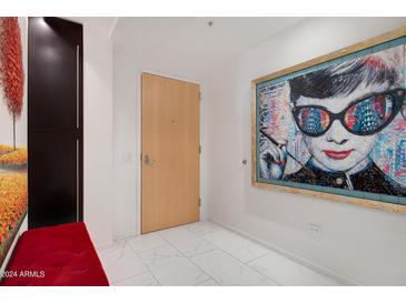 Modern entryway with large artwork and a red bench at 7157 E Rancho Vista Dr # 3006, Scottsdale, AZ 85251