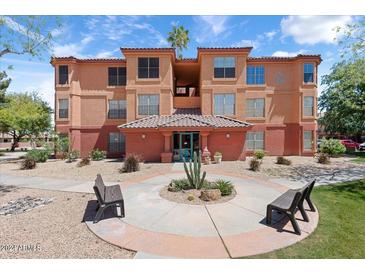 Two-story building exterior with landscaping and benches at 14950 W Mountain View Blvd # 5101, Surprise, AZ 85374