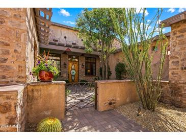Ornate iron gate leads to the home's entrance at 28080 N 101St St # 116, Scottsdale, AZ 85262
