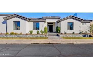 Modern single-story home with a clean, white facade at 11905 N 83Rd Pl, Scottsdale, AZ 85260