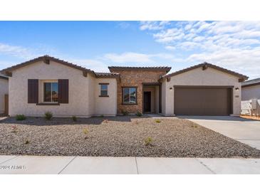 New single story home with a two-car garage and stone accents at 37607 W Padilla St, Maricopa, AZ 85138