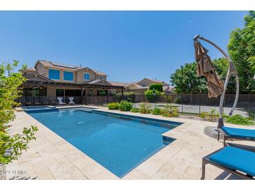 Inviting pool area with lounge chairs and an umbrella at 3314 E Azalea Dr, Gilbert, AZ 85298