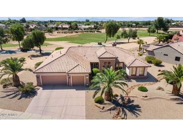 Aerial view of single-story house with two-car garage and desert landscaping at 15717 W Linksview Dr, Surprise, AZ 85374