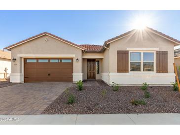 One-story home with brown garage door and desert landscaping at 16399 W Avenida Del Sol --, Surprise, AZ 85387