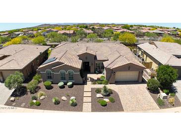 Aerial view of a house with a tile roof and a landscaped yard at 12349 W Tyler Trl, Peoria, AZ 85383