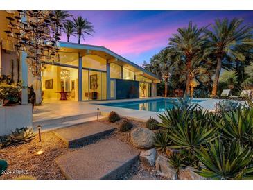 Stunning pool and patio area with mountain views at sunset at 8517 N 48Th Pl, Paradise Valley, AZ 85253