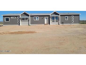 Single-story home with gray siding and a neutral color scheme at 1653 S 360Th Ave, Tonopah, AZ 85354