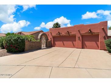 Three-car garage with an inviting arched entryway at 886 W St Andrews Dr, Casa Grande, AZ 85122