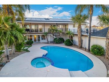 Kidney shaped pool and spa at 6875 E Lone Mountain Rd, Scottsdale, AZ 85266